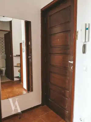 a wooden door in a room with a mirror at Voga Apartments Marquês in Porto