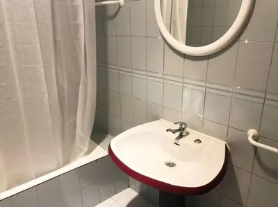 a bathroom with a white sink and a mirror at Covelo 90 in Porto