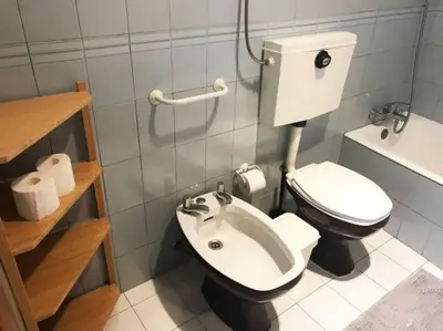 a small bathroom with a toilet and a sink at Covelo 90 in Porto