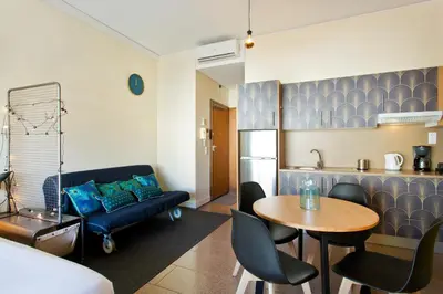 a living room with a couch and a table at Trindade City Studio 77 in Porto