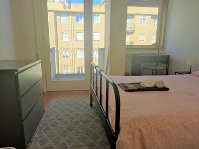 a bedroom with a bed and a large window at DISCOVER PORTO - Boavista 3 in Porto