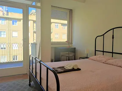 a bedroom with a bed and a large window at DISCOVER PORTO - Boavista 3 in Porto
