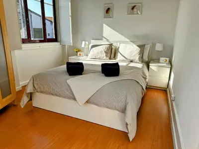 a bedroom with a bed with two pillows on it at Figueiroa 10 in Porto