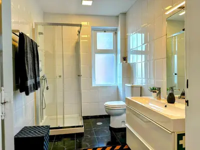 a bathroom with a toilet and a shower and a sink at Figueiroa 10 in Porto