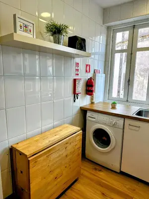 a kitchen with a washing machine and a washer at Figueiroa 10 in Porto