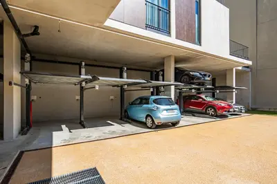 a parking lot with two cars parked in it at BONFIM LIVING - Great location, al fresco dining and free private parking in Porto