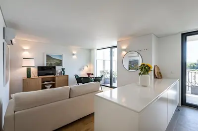 a living room with a couch and a table at BONFIM LIVING - Great location, al fresco dining and free private parking in Porto