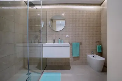 a bathroom with a shower and a sink and a mirror at BONFIM LIVING - Great location, al fresco dining and free private parking in Porto