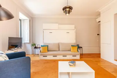 a living room with a couch and a tv at D&S - Palácio dos Príncipes in Porto