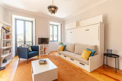 a living room with a couch and a tv at D&S - Palácio dos Príncipes in Porto