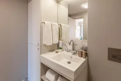 a white bathroom with a sink and a mirror at D&S - Palácio dos Príncipes in Porto
