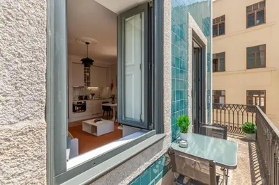 a balcony with a view of a living room at D&S - Palácio dos Príncipes in Porto