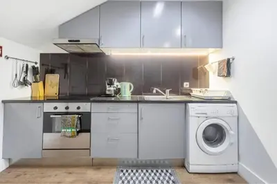 a kitchen with a sink and a washing machine at Gaia Style Room in a Shared Apartment in Vila Nova de Gaia