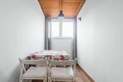 a table and two chairs in a room with a window at Gaia Style Room in a Shared Apartment in Vila Nova de Gaia