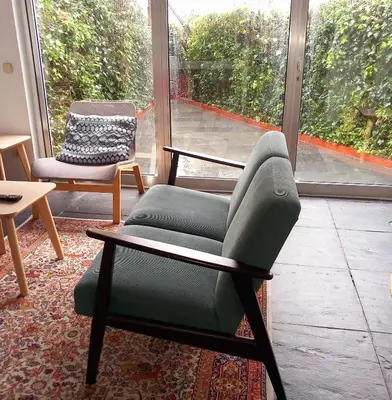 a living room with a couch and a chair at Apartment with Private Garden in Porto