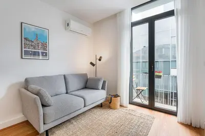 a living room with a couch and a large window at GuestReady - Tranquility in downtown in Porto
