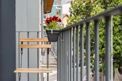 a balcony with a bench and a planter with red flowers at GuestReady - Tranquility in downtown in Porto