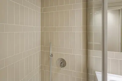 a bathroom with a shower with a glass door at Blissful Suites Porto by gaiarooms in Porto