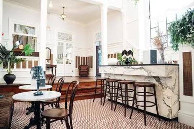 a room with tables and chairs and a fireplace at GRANDE HOTEL PARIS by STAY HOTELS in Porto