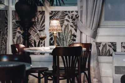 a dining room with a table with chairs and a lamp at GRANDE HOTEL PARIS by STAY HOTELS in Porto