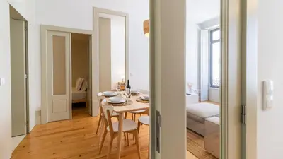 a dining room and living room with a table and chairs at Formosa Delight by LovelyStay in Porto