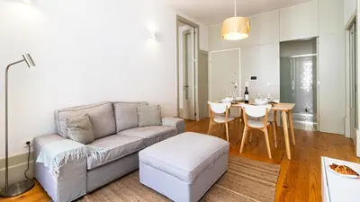 a living room with a couch and a table at Formosa Delight by LovelyStay in Porto