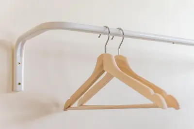 a wooden hanger hanging from a metal rack at GuestReady - October Tide in Porto