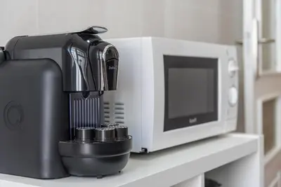 a coffee maker and a microwave on a counter at GuestReady - October Tide in Porto