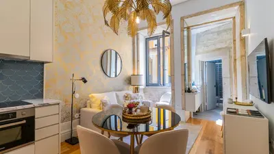 a kitchen and living room with a table and chairs at Downtown PortoEdition in Porto