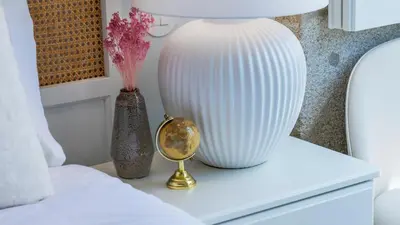 a white vase sitting on a table next to a lamp at Downtown PortoEdition in Porto