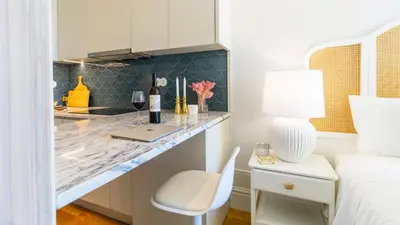 a bedroom with a desk with a laptop and a bed at Downtown PortoEdition in Porto