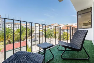two chairs on a balcony with a view of a street at GuestReady - Serene stay in Porto in Porto