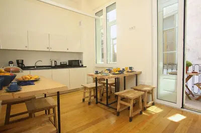 a kitchen with wooden tables and chairs in a room at Nº 91 - Almirante Guest House in Porto
