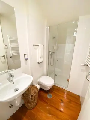 a bathroom with a sink and a toilet and a shower at Nº 91 - Almirante Guest House in Porto