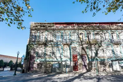 an old building with graffiti on the side of it at Porto's Legacy by Upperground in Porto