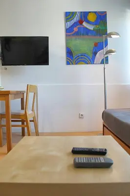 a living room with a couch and a table at Oporto Early Sunshine Apartment in Porto