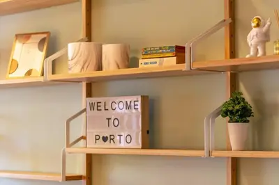 a shelf with a welcome to portonia sign on it at Casa da Praça in the center of Porto - GuestSPA in Porto