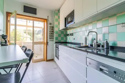 a kitchen with a sink and a table with chairs at Casa da Praça in the center of Porto - GuestSPA in Porto