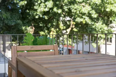 a wooden chair sitting on top of a wooden table at GuestReady - Lux staycation in Boavista in Porto