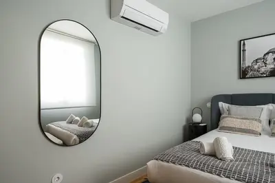 a bedroom with a mirror and a bed at GuestReady - Lux staycation in Boavista in Porto