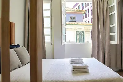 a bedroom with a bed with towels on it at Oporto Sweet Downtown 1 in Porto