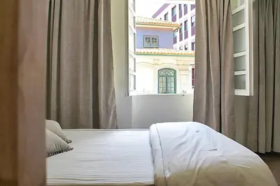 a bed in a room with a large window at Oporto Sweet Downtown 1 in Porto
