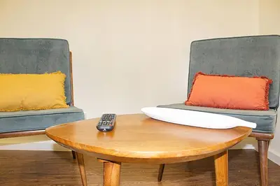 a remote control sitting on a table next to two chairs at Oporto Sweet Downtown 2 in Porto