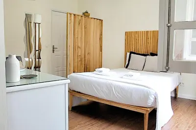 a bedroom with a bed with a wooden headboard at Oporto Sweet Downtown 3 in Porto