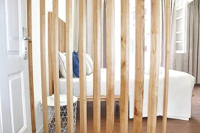 a wooden crib with a chair in a bedroom at Oporto Sweet Downtown 3 in Porto