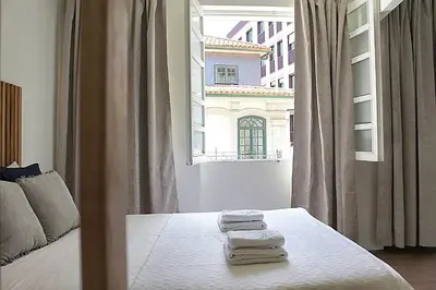 a bedroom with a bed with towels on it at Oporto Sweet Downtown 3 in Porto
