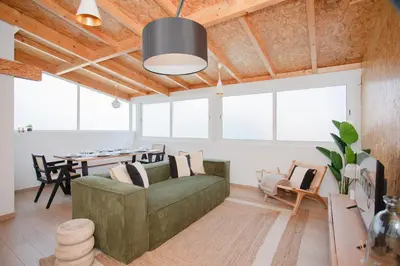 a living room with a green couch and a table at Liiiving in Porto - Downtown Quiet House in Porto