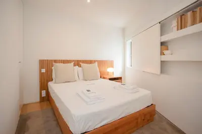 a bedroom with a large bed with white sheets at Liiiving in Porto - Cedofeita Green Terrace in Porto