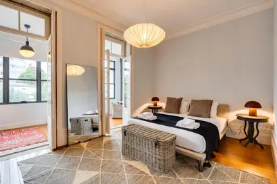 a bedroom with a king sized bed and a living room at Porto Premium Villa in Porto