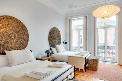 a bedroom with two beds and a large window at Porto Premium Villa in Porto